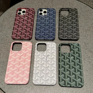 Six phone cases in a repeating chevron pattern, in burgundy, navy, green, pink, white and grey
