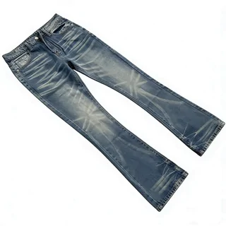 One pair of faded blue denim jeans laid flat on a white surface