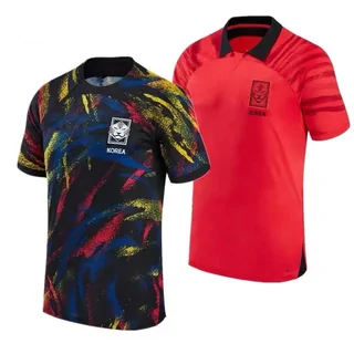 Two football shirts side by side, one black with a multicoloured print and one plain red, both with a national crest